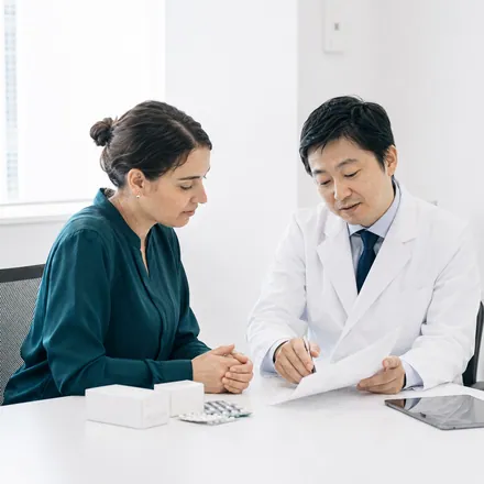 Doctor reviewing a patient's medication list before stem cell therapy in Japan